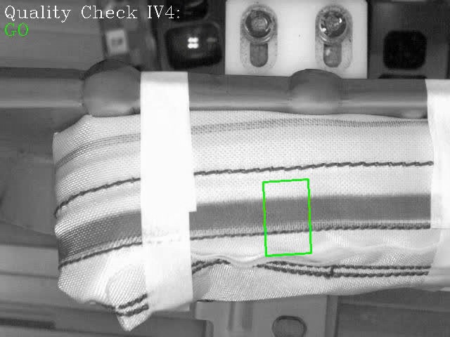 Detection view of a stitched seatbelt component with a region of interest boxed and marked GO