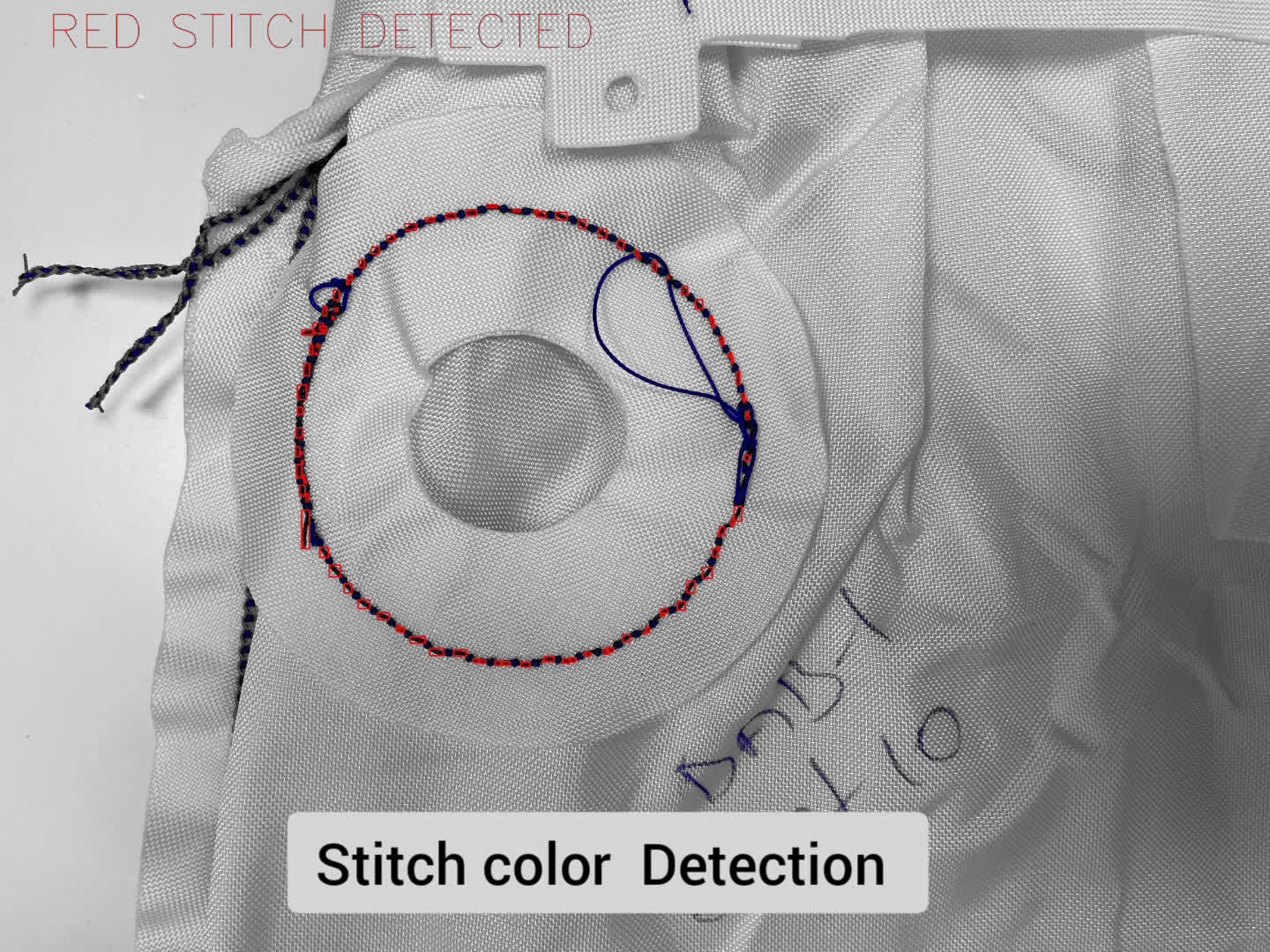 Detection view of a circular stitched seam with red thread color detected and boxed
