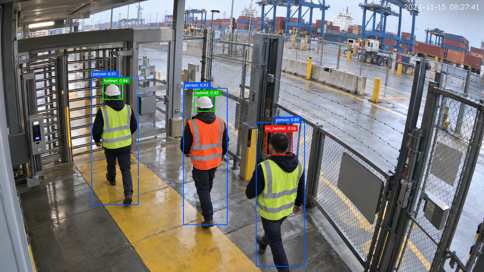 Detection view of three workers walking through a turnstile entry, each boxed as a person, two labelled helmet and one flagged as no_helmet