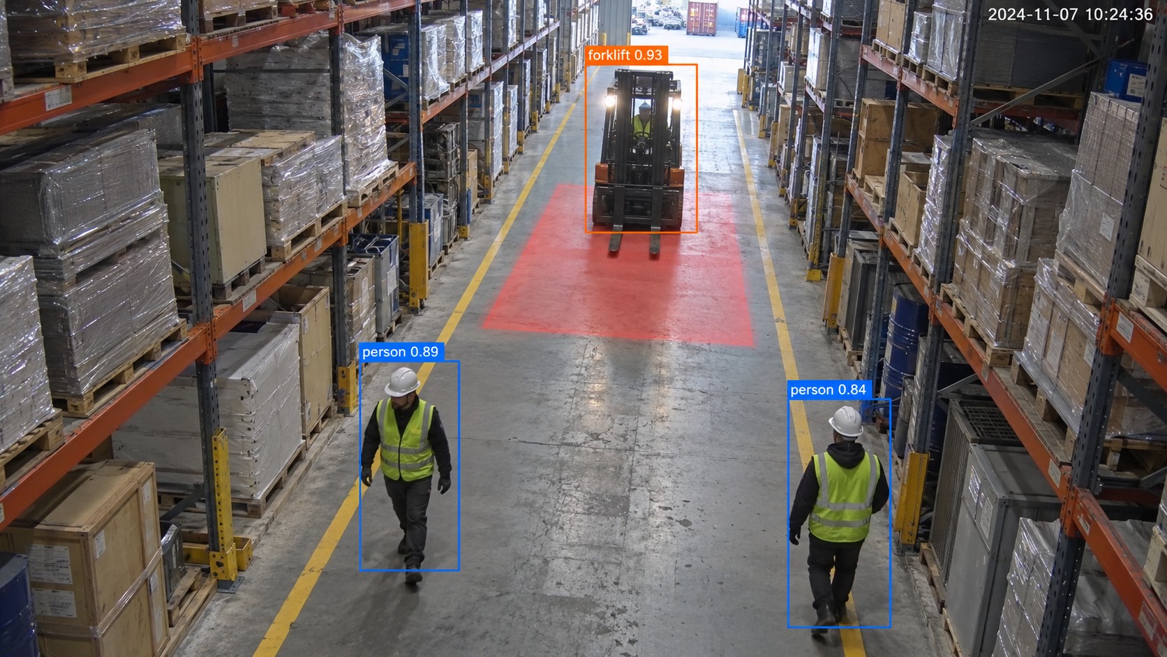 Detection view of a forklift approaching two workers in a warehouse aisle, with the forklift danger zone highlighted and each worker boxed as a person