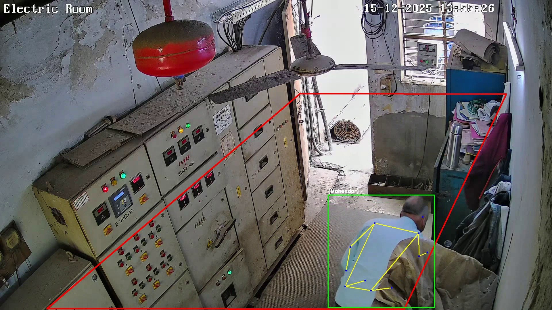 Electric room camera view with a red zone outline around the control panels and a person tracked inside it