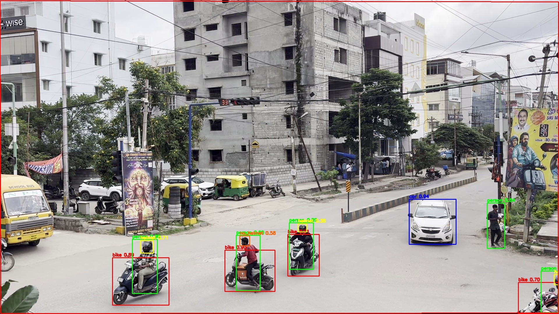 Wide-angle intersection view with multiple autos, cars and bikes boxed and classified across the junction