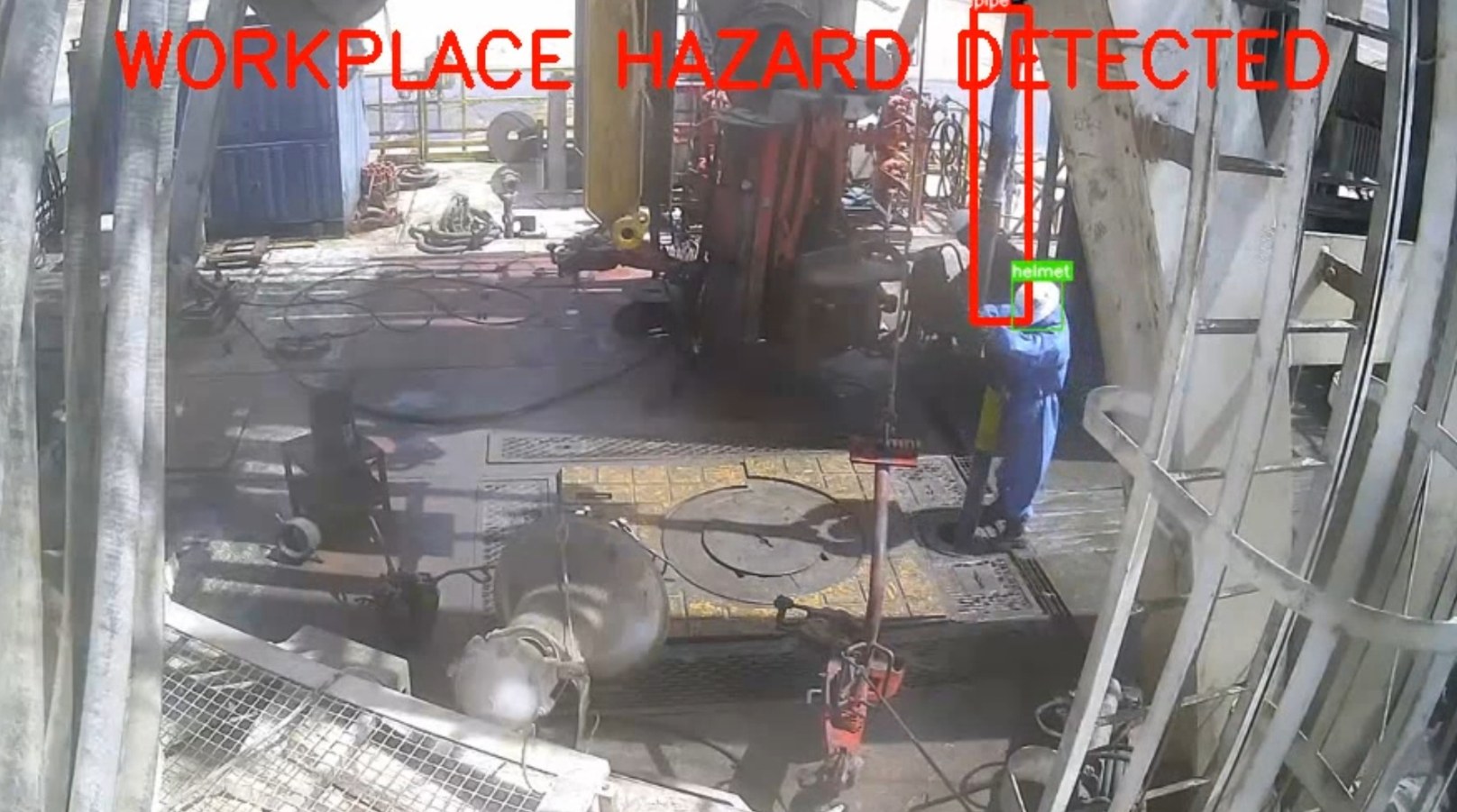 Wide-angle rig camera feed with a WORKPLACE HAZARD DETECTED banner, a worker's helmet boxed near an overhead pipe